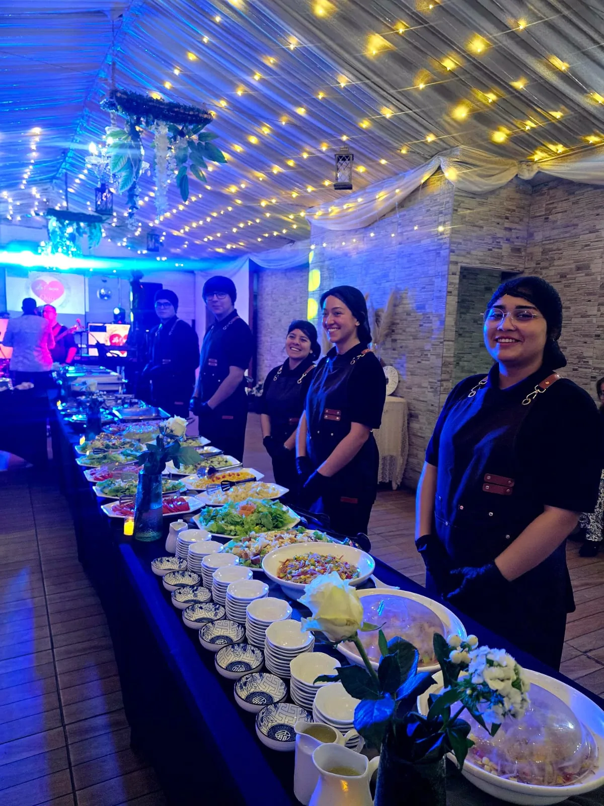 Equipo de banquetería preparando el servicio para una celebración