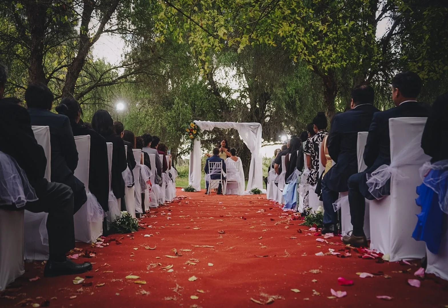 Ceremonia de matrimonio con alfombra roja en los jardines
